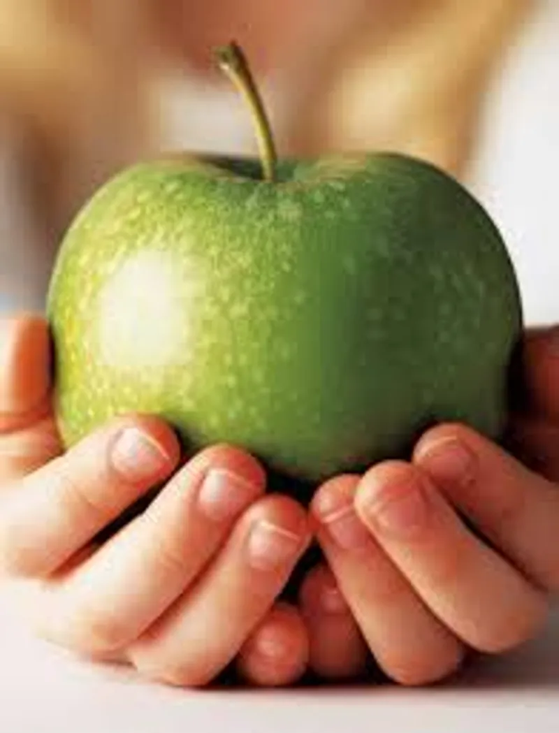 a blacked guy with a pink dyed hair in the market buying oranges